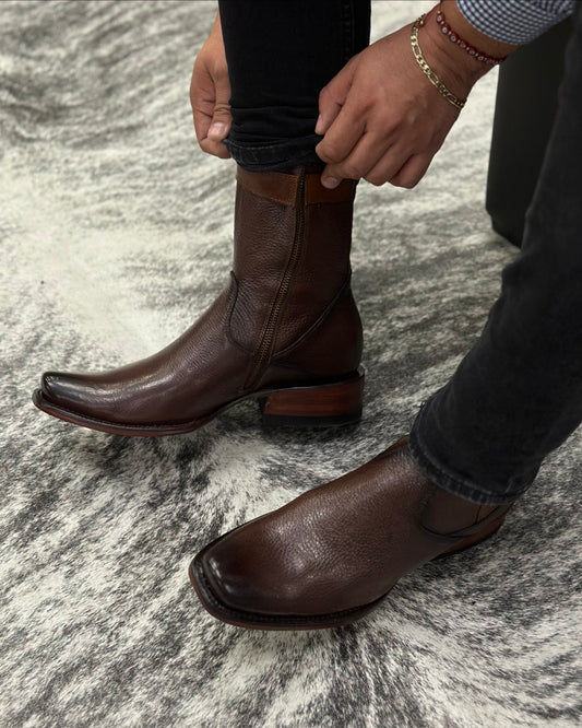 Shiny dark brown cowboy leather boots